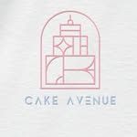 the cake avenue logo is shown in pink and blue on a white t - shirt