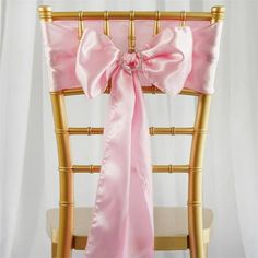 a chair with a pink sash tied to it