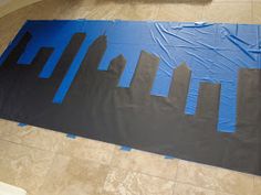 a blue cityscape is taped to the floor