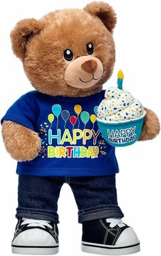 a brown teddy bear holding a cupcake and wearing a happy birthday t - shirt