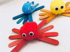 three hand puppets with googly eyes and hands painted to look like octopus's