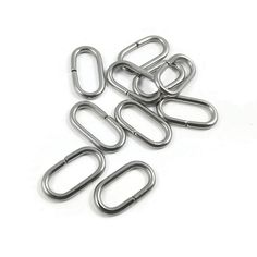 five metal paper clips on a white background