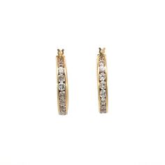 14k yellow gold hoop earring featuring a total of 40 round cubic zirconia in a channel-type setting. These are not real diamonds in these particular earrings but they sure do sparkle! Set in solid 14k yellow these are built to last. These can be dressed up or down and will complement just about any ensemble! (1" diameter, 5.6g) Please keep in mind these vintage styles are hard to come across, they are one of a kind pieces that are pre-loved and may have some signs of usage! All items cleaned and steamed prior to shipment! If you have any questions regarding size, weight, shipping, conditions, returns or otherwise, please feel free to reach out and contact us :) Luxury Small Hoop Earrings With Channel Set, Gold Diamond Earrings Channel Set Round Cut, Gold Channel Set Round Cut Diamond Earrings, Gold Round Cut Channel Set Diamond Earrings, Gold Channel Set Diamond Earrings For Anniversary, Gold Channel Set Hoop Earrings For Anniversary, Gold Diamond Earrings Channel Set For Anniversary, Classic Yellow Gold Hoop Earrings With Sparkling Stones, Channel Set Hoop Diamond Earrings For Anniversary