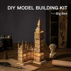 the model building kit is next to an old book and some other items on a table