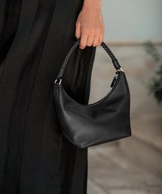 Crescent Shoulder Bag BlackMade of buttery soft lambskin and perfectly sized to fit the essentials, the Crescent Shoulder Bag is an iconic upgrade for your everyday. 100% soft leather. Handmade in Italy.Features a leather-covered rope shoulder strap, zip closure, and interior card pocket. Leather Baguette Bag With Round Handle For Everyday, Chic Baguette Bag With Leather Lining For Everyday Use, Classic Evening Shoulder Bag With Braided Handles, Elegant Shoulder Bag With Braided Handles For Work, Elegant Baguette Bag With Braided Handles, Evening Leather Baguette Bag With Leather Handles, Leather Baguette Shoulder Bag With Braided Handles, Leather Bags With Braided Handles For Work, Leather Baguette Bag With Braided Handles