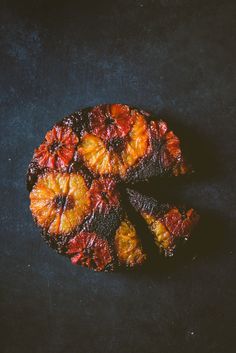 a piece of fruit cake sitting on top of a black table next to a knife