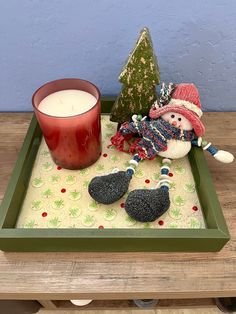 a candle and some ornaments on a tray