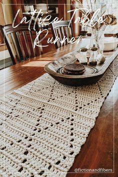 a crocheted table runner on top of a wooden table