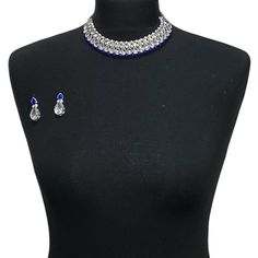 a black mannequin with blue and silver jewelry on it's neckline