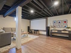 a living room filled with furniture and a projector screen