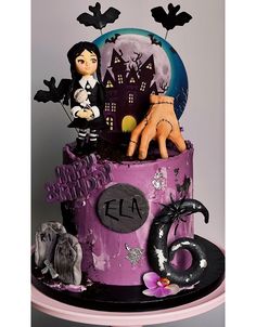 a purple cake decorated with halloween decorations