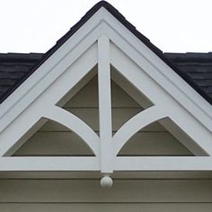 the corner of a house with a white roof