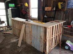 a bar made out of wooden pallets in a garage