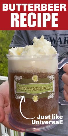 a person holding a cup with whipped cream in it and the words butterbeeer recipe below