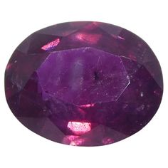 an oval cut amethorate stone with purple hues on the outside and inside