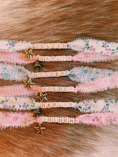 four hair clips with gold stars on them sitting next to some furry material and fur