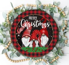 a merry christmas sign with two deers and holly wreath around it on a white background