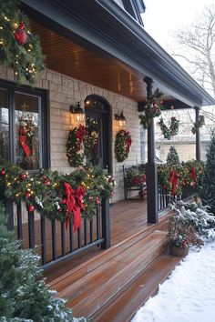 christmas wreaths on the front porch of a house