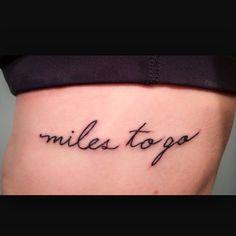 a woman's stomach with the words miles to go tattooed on it