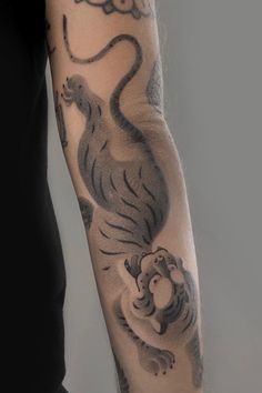 a person with a tiger tattoo on their arm