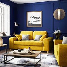 a living room with blue walls and yellow furniture