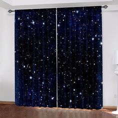 an open window with stars on it and blue curtains hanging from the side, in front of a wooden floor