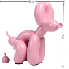 a pink balloon dog sitting next to a small vase on a white background with measurements