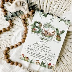 an animal themed baby shower is displayed on a wicker mat with beads and shells