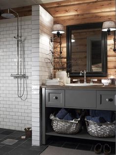 a bathroom with a sink, mirror and shower stall in it's center area