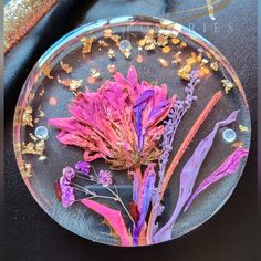 a glass plate filled with flowers on top of a table