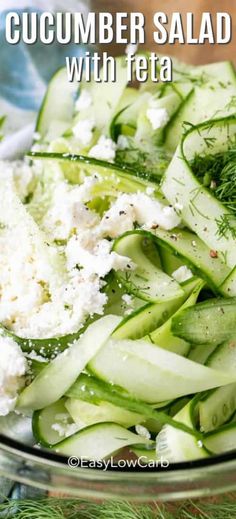 cucumber salad with feta and dill in a glass bowl on a table