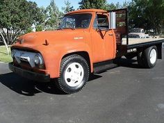 an orange truck parked in a parking lot