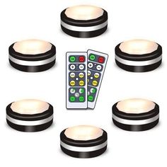 the remote controls are placed on top of the black and white discs with different colored buttons