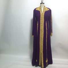 Royal plum purple hostess gown with elaborately stitched gold soutache from the 1960s. Vintage loungewear full length gown has no labels, likely purchased on a trip abroad to the Middle East or the Mediterranean. Midweight polyester knit with a nice amount of give. Back zipper. Maker not known, handmade by a tailor Material synthetic knit Care dry clean Suggested modern size Curvy 10 (please check measurements for accurate fit) measurements (taken flat then doubled) Bust 33" Waist 33" Hip 34" Sl Long Sleeve Purple Party Kaftan, Formal Purple Embroidered Gown, Purple Floor-length Abaya, Purple Embroidered Floor-length Gown, Elegant Purple Evening Kaftan, Purple Embroidered Maxi Gown, Purple Embroidered Maxi Length Gown, Embroidered Purple Maxi Gown, Elegant Purple Embroidered Kaftan