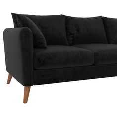 a black velvet couch with wooden legs and pillows on it's backrests