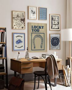 a home office with posters on the wall