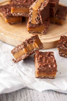 pieces of chocolate peanut butter bars on a cutting board