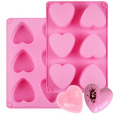 two heart shaped ice trays next to each other with chocolate hearts in the middle