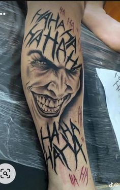 the joker tattoo is on someone's leg and it looks like he has been painted