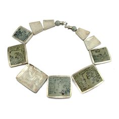 95% Pure Silver with 19th Century Pottery Fragments Necklace Approx. 19" long Bead Approx. 1 1/8 x 1 1/8" to 2 3/8" x 2" Hand finished and etched hammered 95% Thai Pure Silver Handcrafted in Northern Thailand Artisan Sterling Silver Rectangular Necklace, Luxury Etched Pendant Necklaces, Elegant Rectangular Etched Necklace, Northern Thailand, Silver Bead Necklace, Pure Silver, Silver Beads, Bracelet Watch, 19th Century