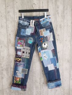 a pair of jeans with patches and buttons on them