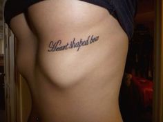 a woman's lower back with the words heard shaped be written on it