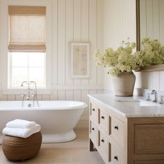 a white bath tub sitting next to a window