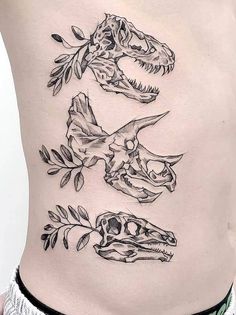 a woman's stomach with three dinosaurs and leaves on the side, all in black ink