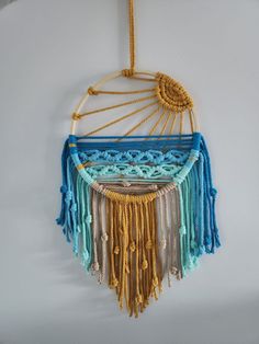 a wall hanging made out of macrame and rope with beads on the end