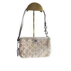 Adorable Coach Wristlet In Tan With Metallic Accents Never Been Used. This Item Offers An Interior Pocket, Leather Wrist Strap, Signature Coach Tag, And Is Constructed Of Cloth With A Leather Strap. Brand: Coach Color: Tan And Metallic Accents Size: Os Style: Leather Wrist Strap, Signature Coach Tag Material: Cloth And Leather Strap Features: Leather Wrist Strap Signature Coach Tag Size: Womens Os Condition: New Without Tags Elegant Silver Wristlet For Everyday Use, Coach Silver Bags For Gifts, Elegant Silver Rectangular Wristlet, Coach Keychain, Coach Wristlet, Wristlet Clutch, Leather Coin Purse, Vintage Coach, Leather Wristlet