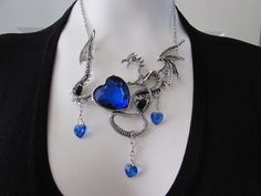 This necklace will set the tone of your outfit. Most unique dragon motif.  Necklace is in nice condition. clasp holds securely. Wear it with your casual jeans or make a statement with that plain dress... Photo shoot opportunity with this one. Blue Gothic Metal Necklace, Gothic Blue Metal Jewelry, Blue Gothic Metal Jewelry, Necklace Dragon, Mermaid Outfit, Gothic Gifts, Alternative Style, Silver Necklace Statement, Dragon Necklace