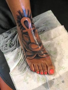 a woman's foot with a tattoo on it