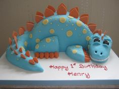 a birthday cake that looks like a dinosaur