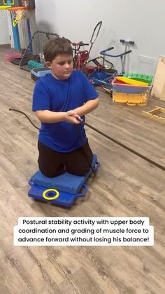 a young boy is sitting on the floor playing with his balance ball while looking at something